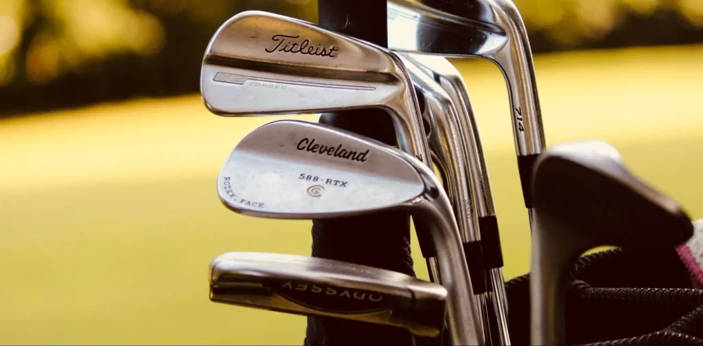 A close-up shot of golf clubs in a golf bag