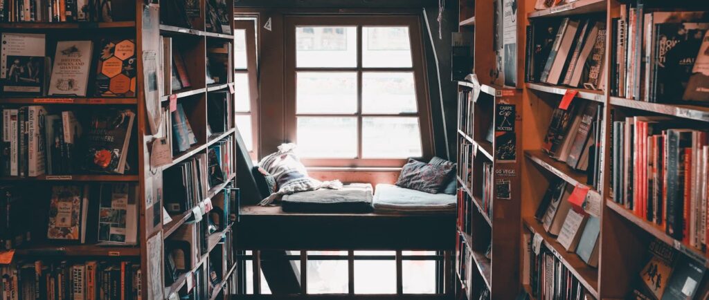 A reading nook in a bookshop, surrounded by shelves