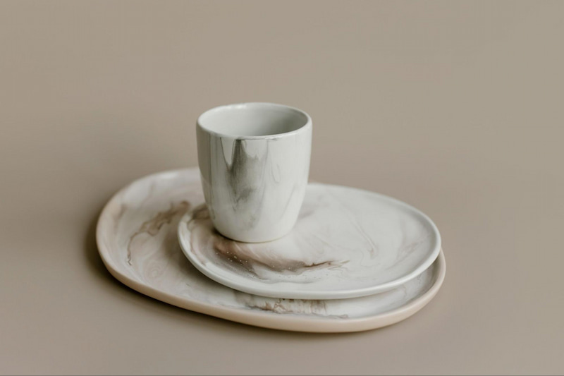 Close up of some off-white crockery on a brown surface